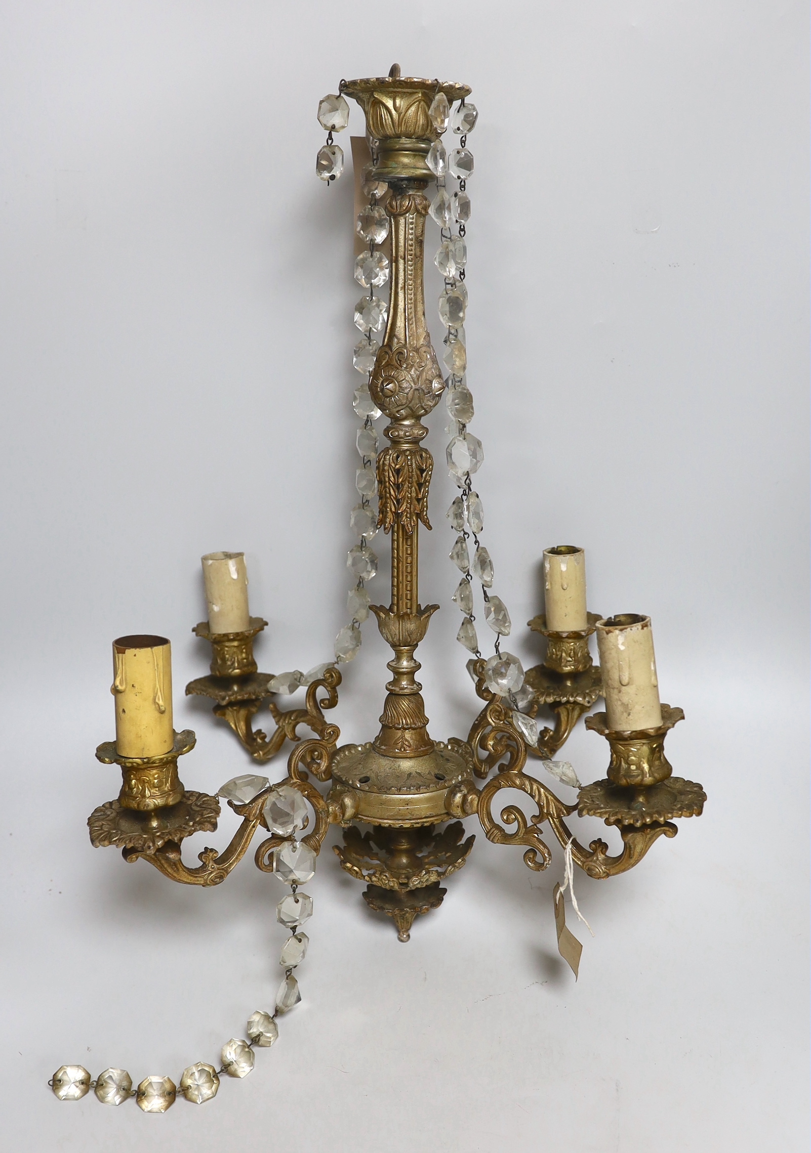 Two gilt metal four-branch chandeliers, with some crystal drops, the largest 52cm high